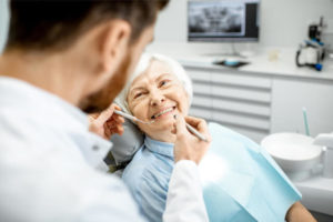 The senior patient smiles first at her dentist before the procedure begin.